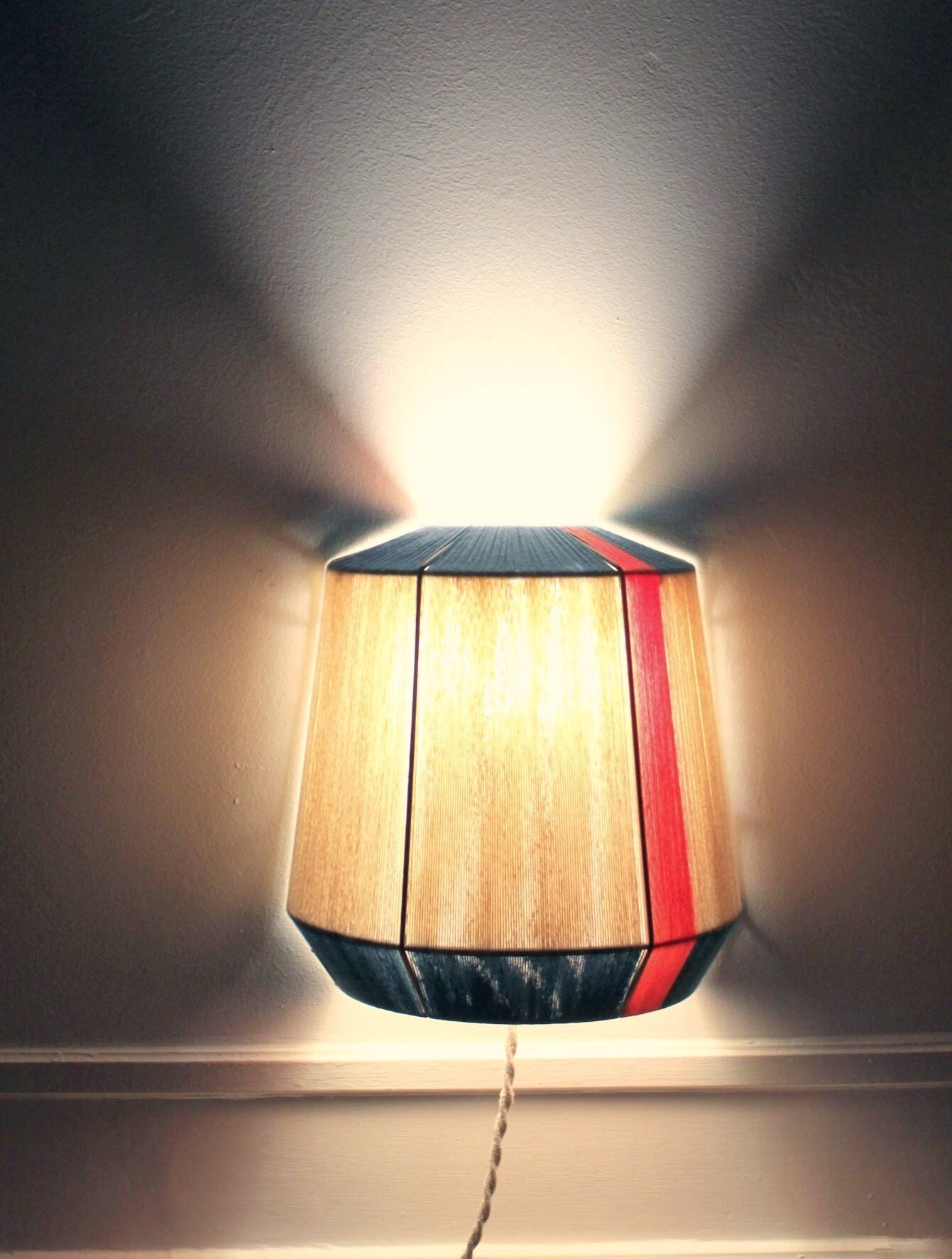 The Epicurienne coral peacock wall light