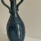 Decorative deep blue glazed ceramic vase with twin handles.