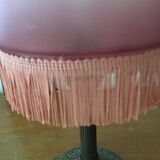 Old table/bedside lamp with glass shade with pink gradients and fringes.