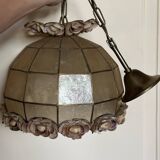 Vintage pendant light with a pearlescent shade and floral decoration.