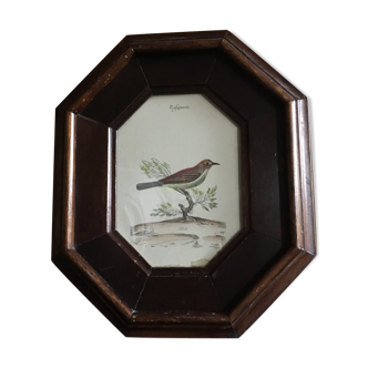 Ancient octagonal frame with bird