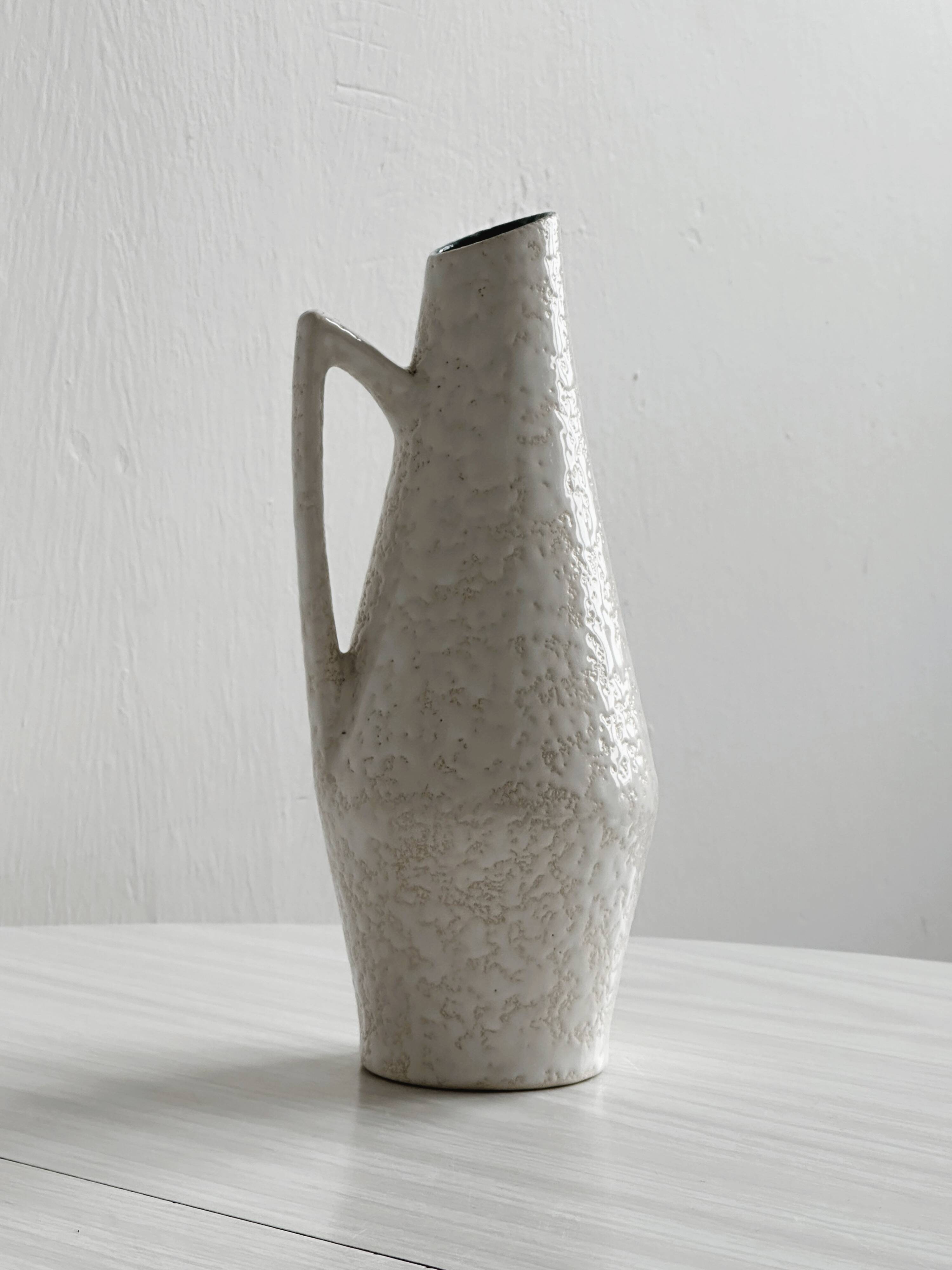 Ceramic flower pitcher.