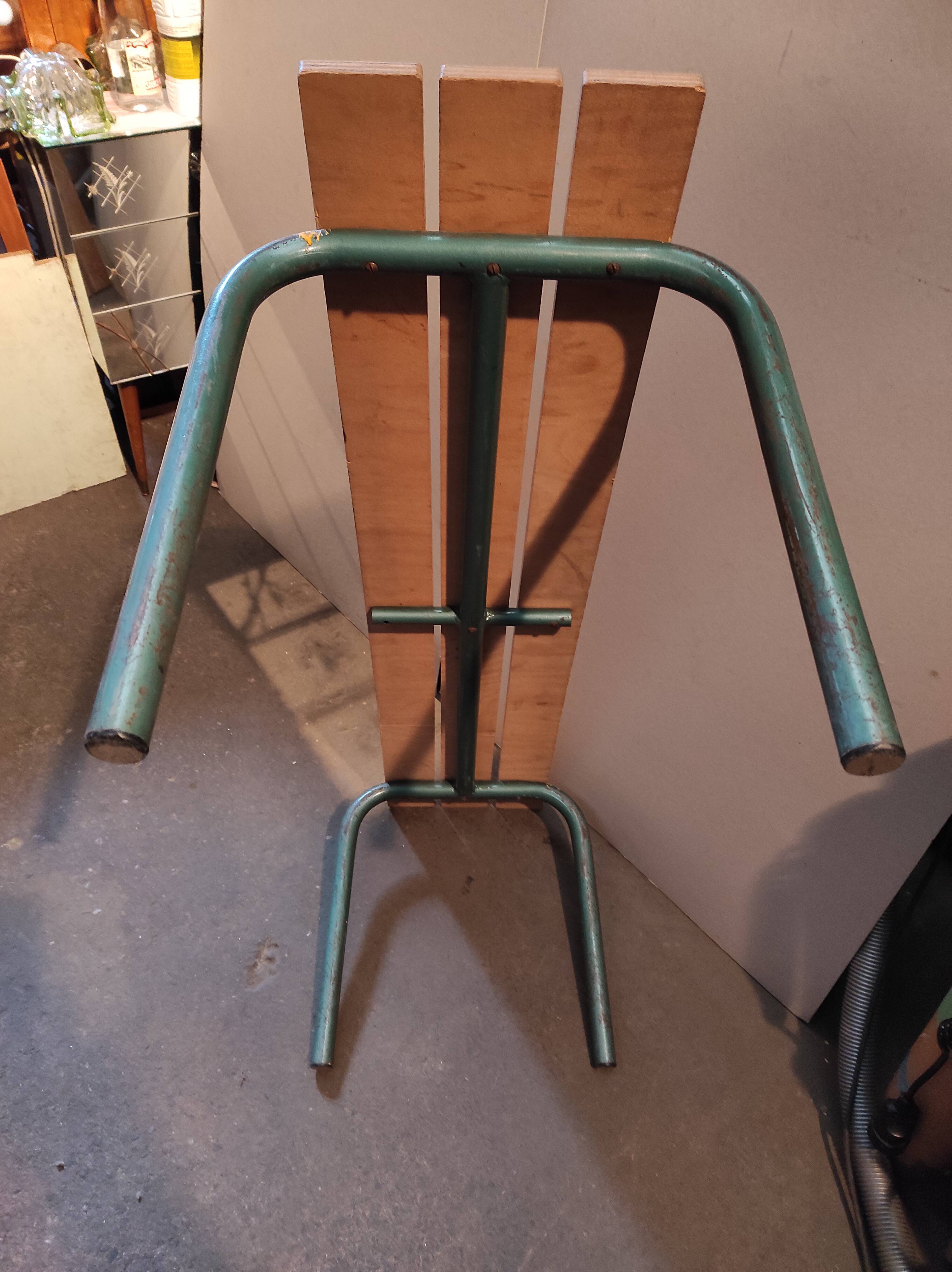 Former vintage wooden school bench and metal tubes