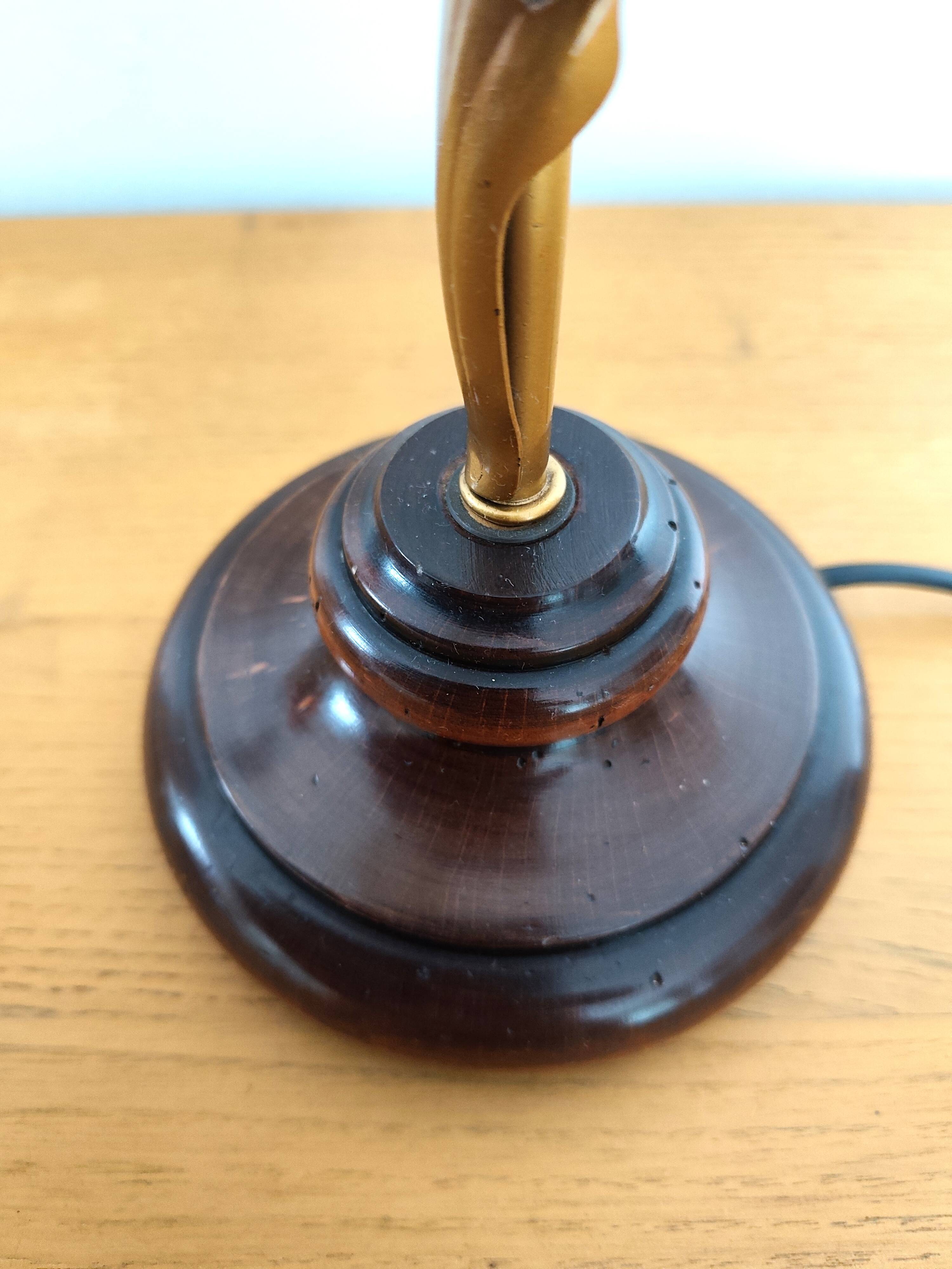 Gold swan neck table lamp with amber tulip glass.