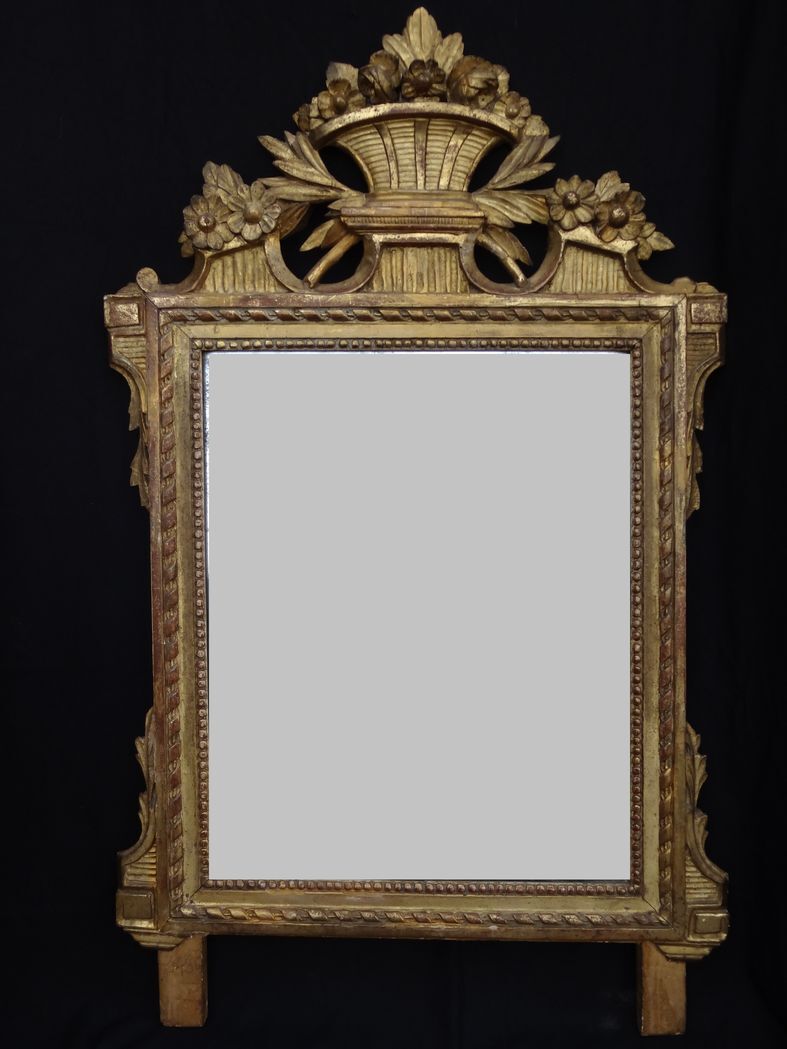 Louis XVI period mirror in gilded carved wood