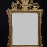 Louis XVI period mirror in gilded carved wood