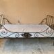 Wrought iron bed with mattress and decorative cover