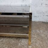 1970s coffee table in brass with a double smoked glass top.