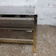 1970s coffee table in brass with a double smoked glass top.