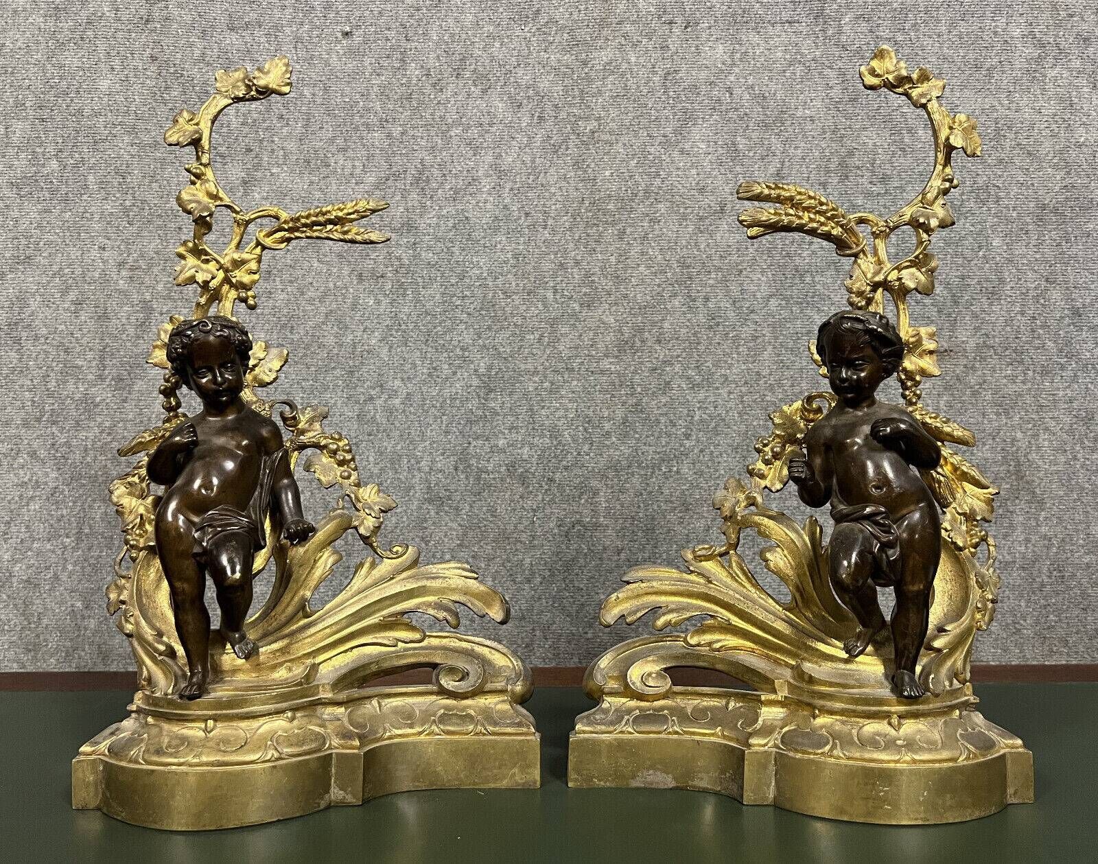 Pair of gilded bronze and patinated bronze andirons depicting putti circa 1850