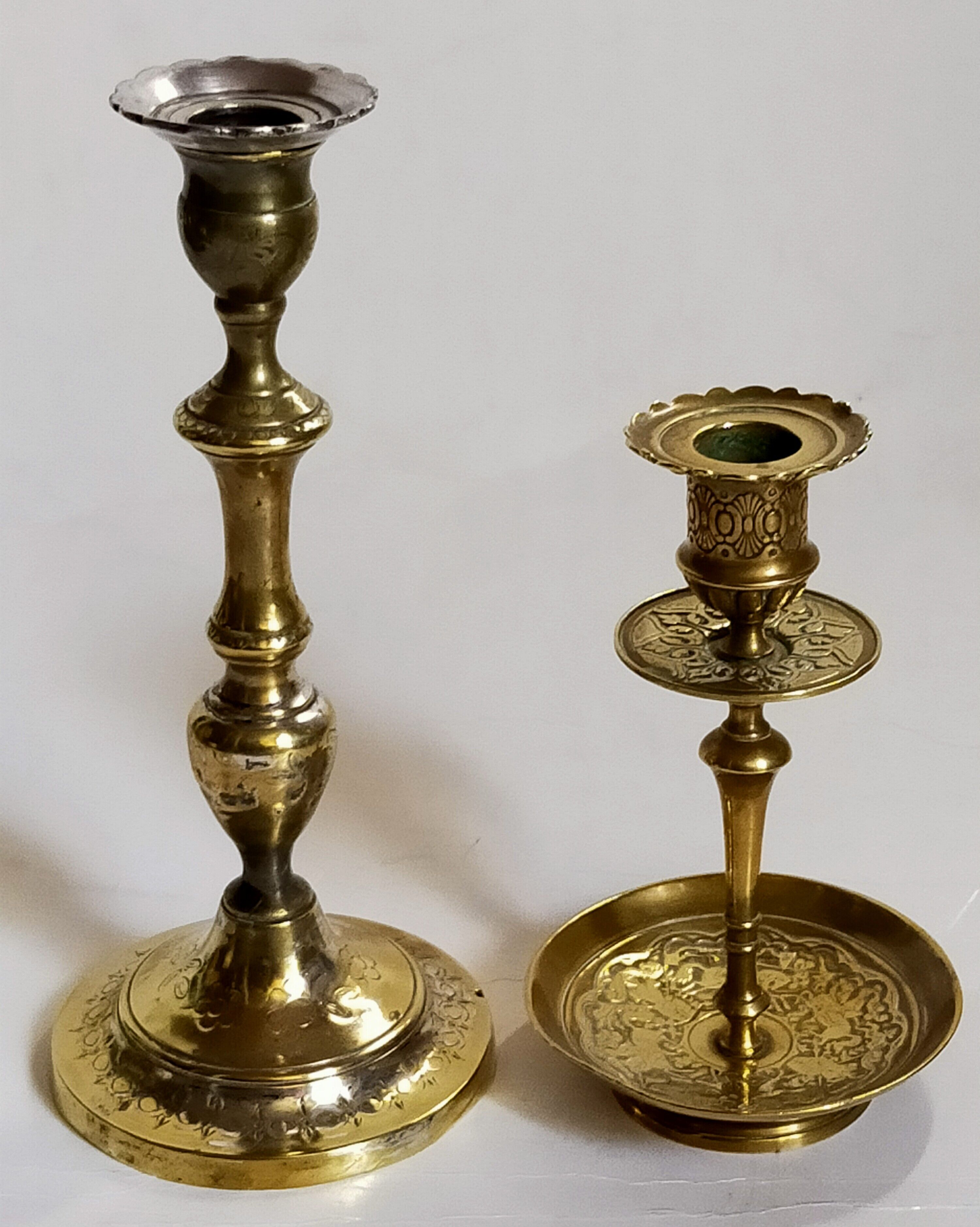 Duo of solid brass and gold metal candle holders worked old