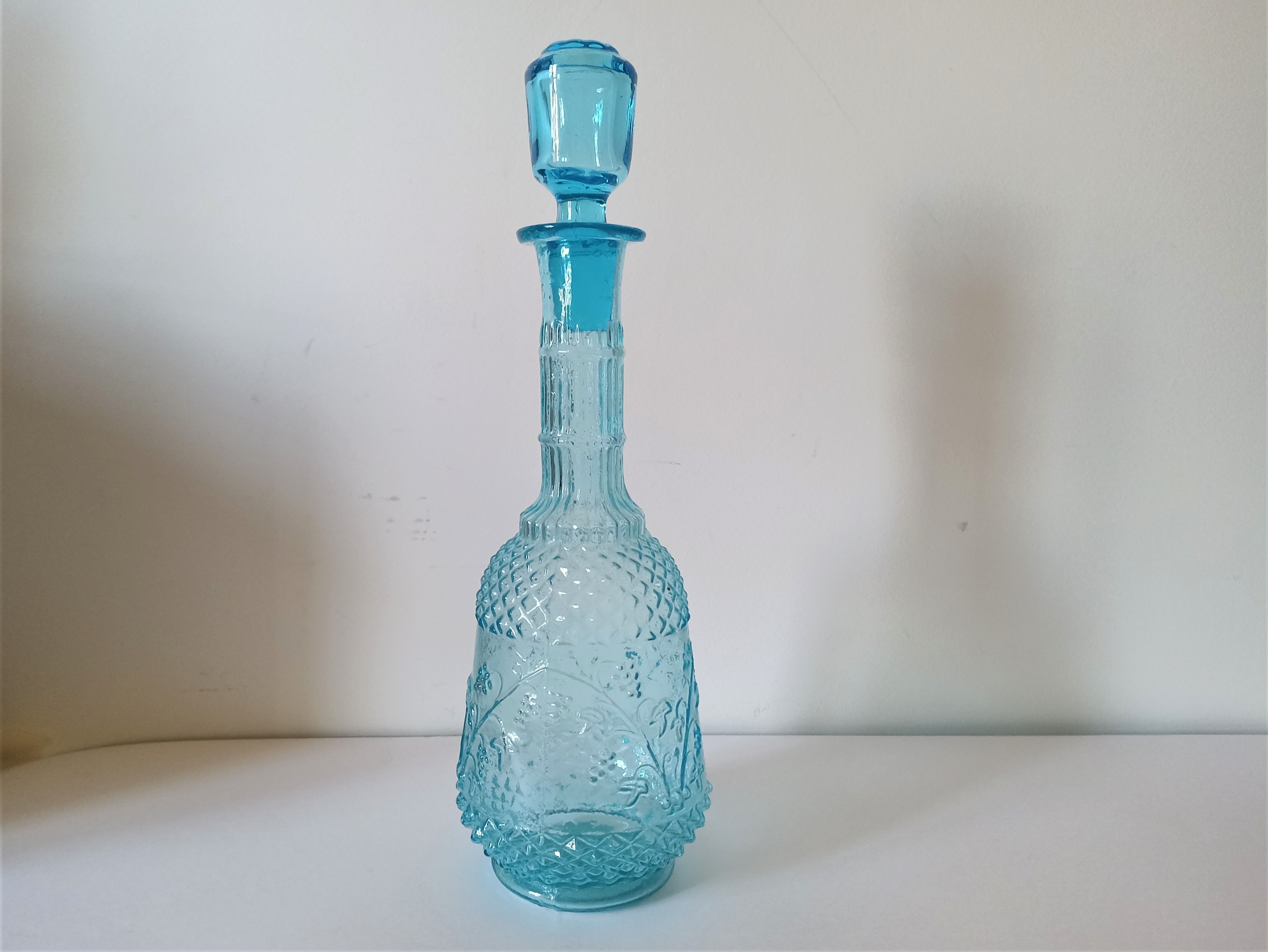 Old turquoise blue molded glass liqueur bottle and its cap