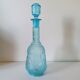 Old turquoise blue molded glass liqueur bottle and its cap