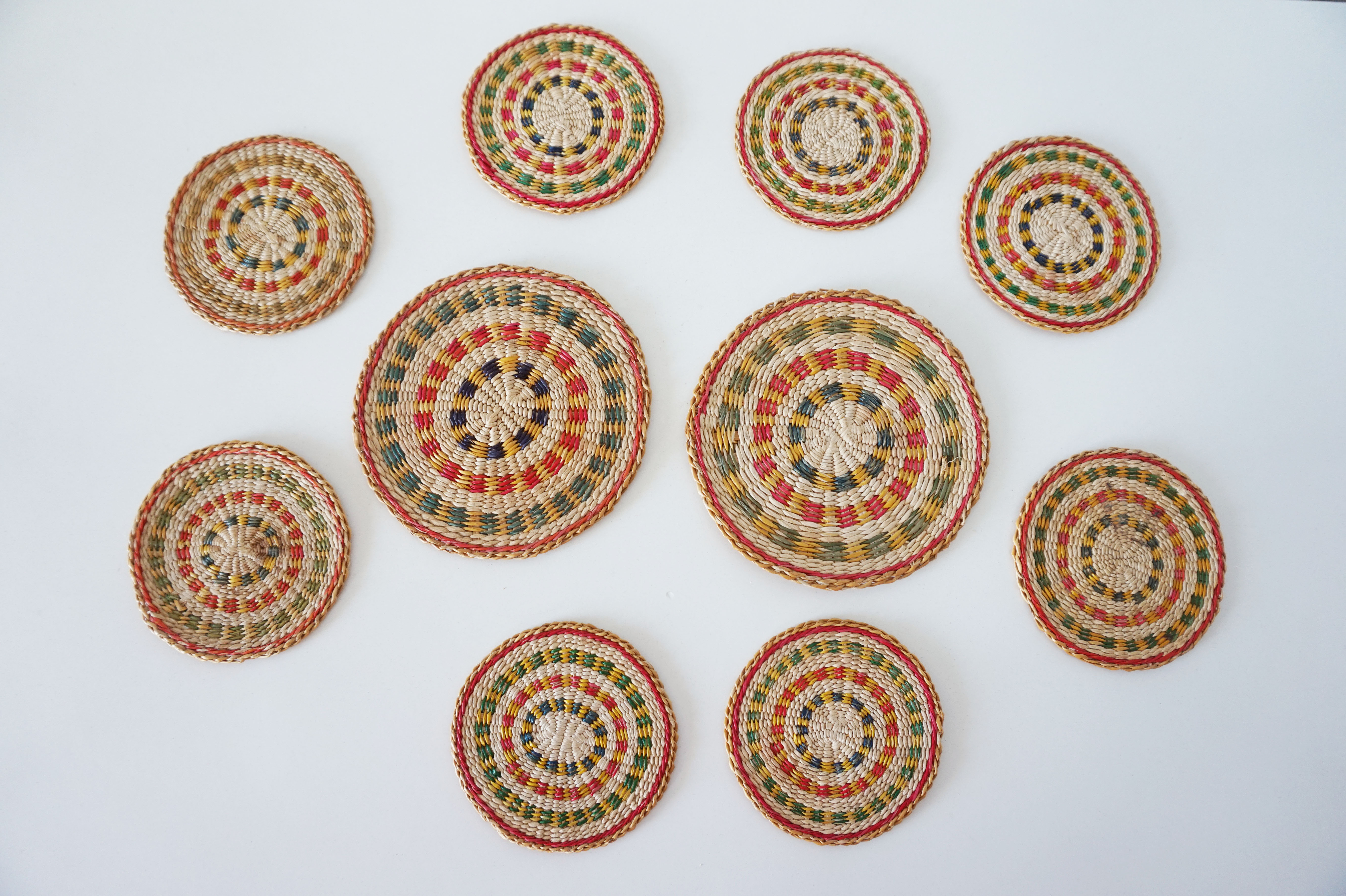 Set of coasters and bottles in colored wicker