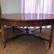 Important central pedestal table in mahogany, brass and bronze that can form a large dining table.