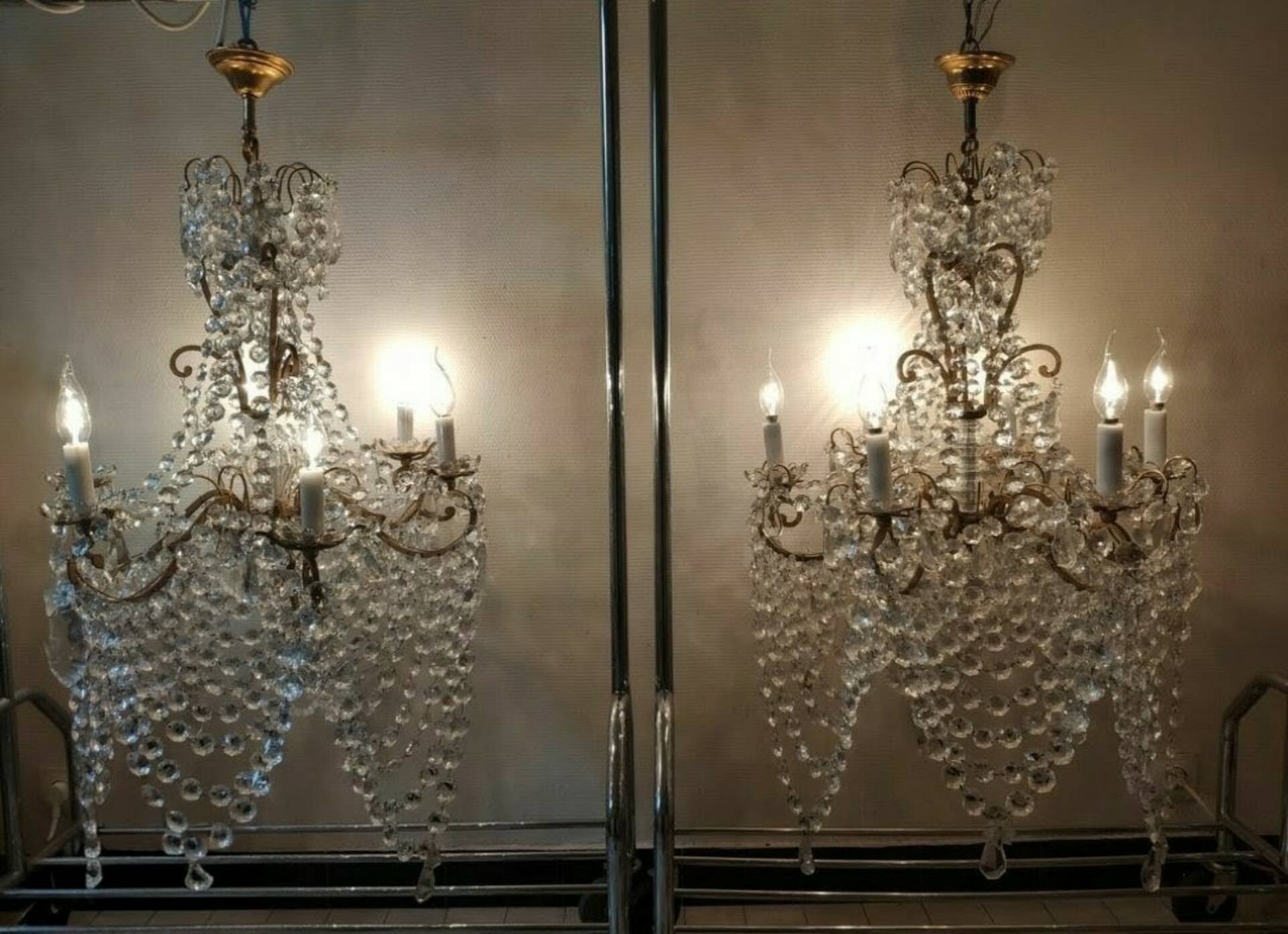 A pair of imposing, antique chandeliers with pendants.
