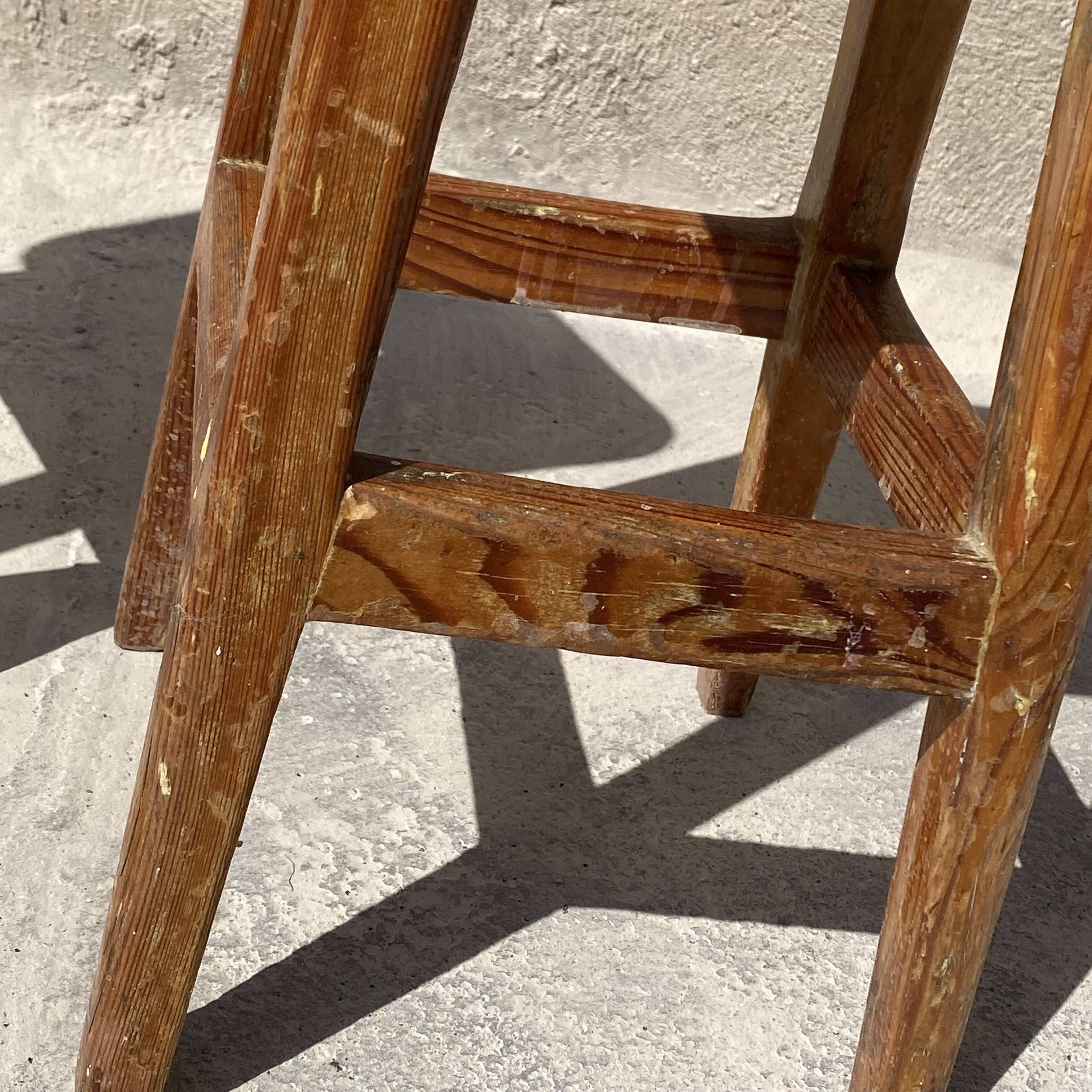Pair of vintage wooden workshop stools with a patina.