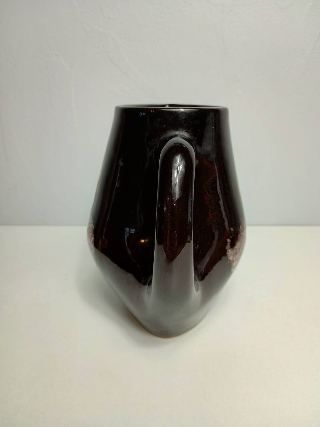 Brown ceramic pitcher with coloured patterns signed Bresse.