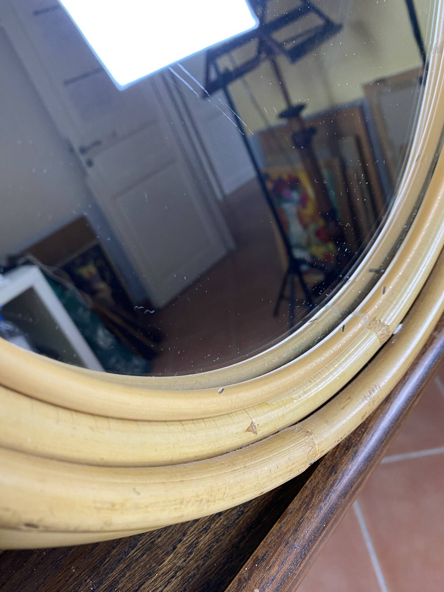 Round mirror from the 1960s with a frame made of rattan and metal.