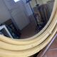 Round mirror from the 1960s with a frame made of rattan and metal.