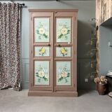 Large antique wardrobe painted with floral decoration.
