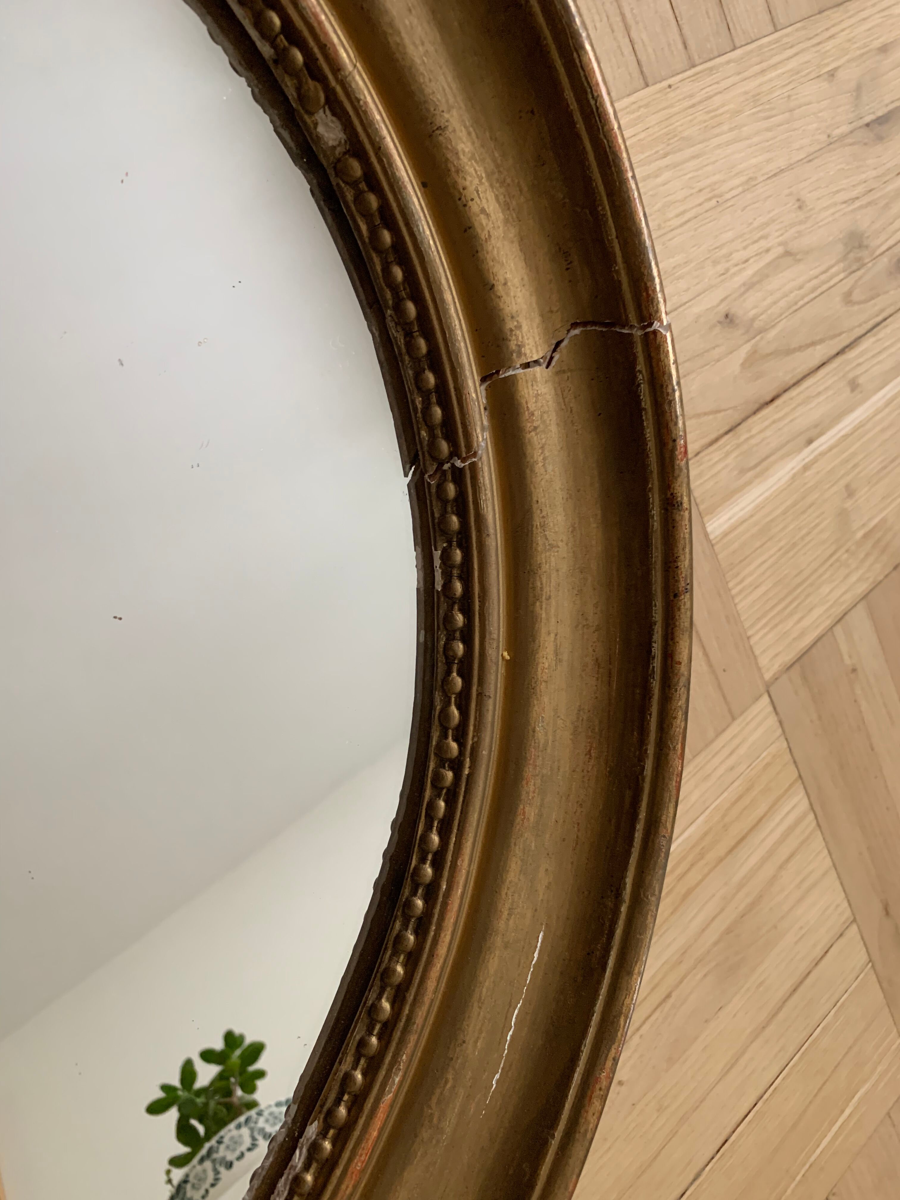 Old oval golden mirror