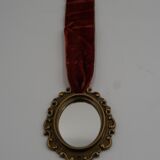 Vintage oval wall-mounted brass mirror