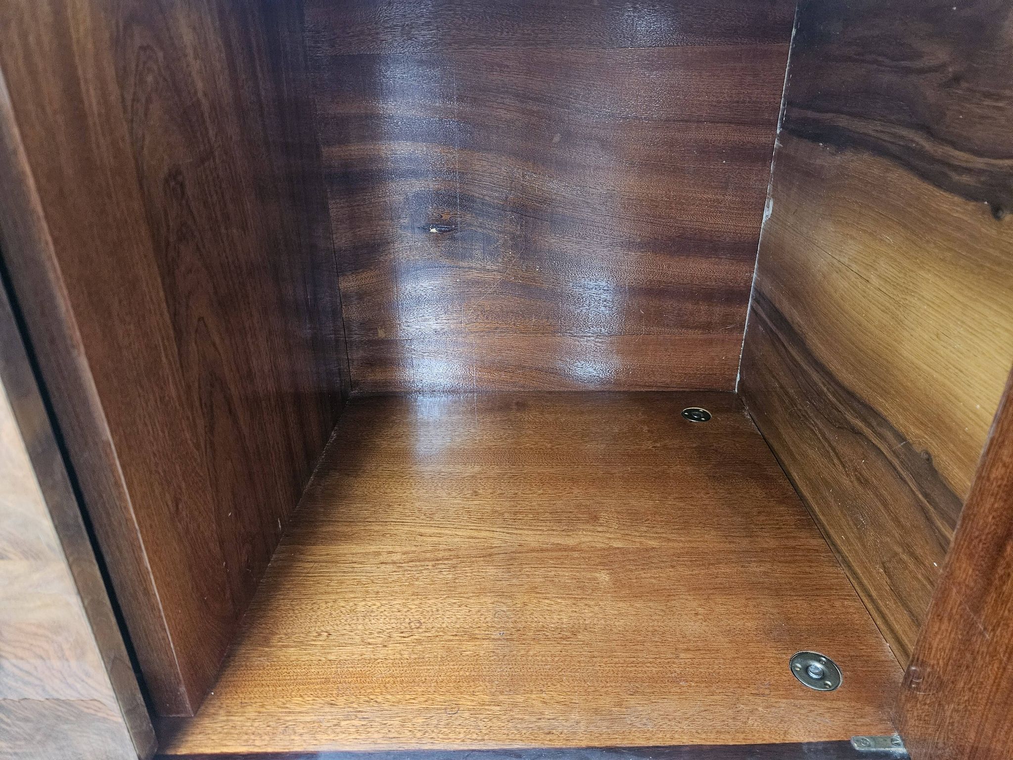 1950s mahogany sideboard with a glass top and central bar.