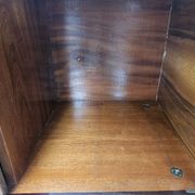 1950s mahogany sideboard with a glass top and central bar.