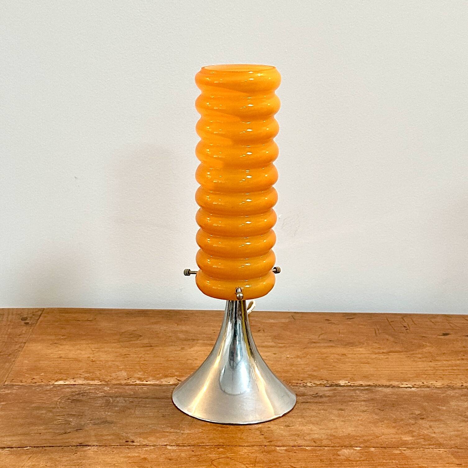 Vintage orange lamp with chrome tulip base and glass shade