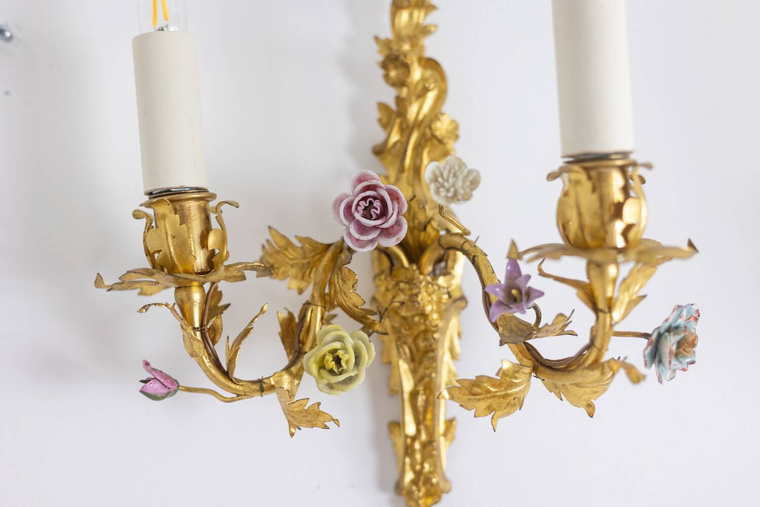 Pair of bronze wall lights with flower decoration. Circa 1880.