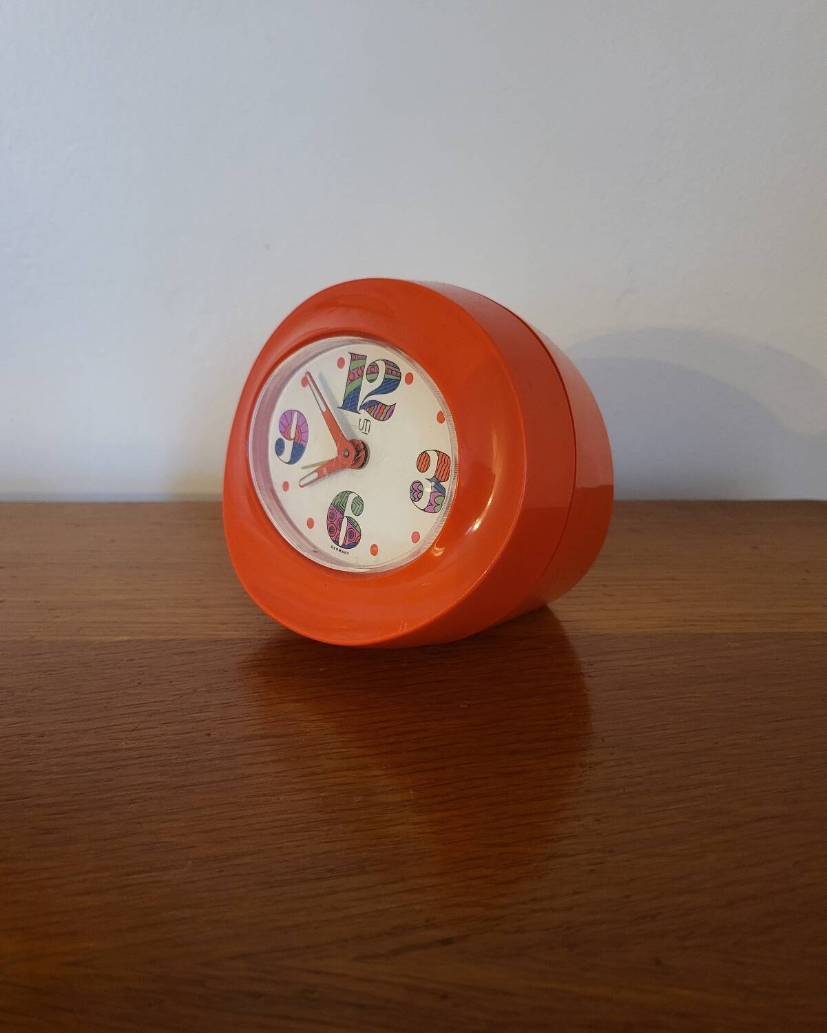 Vintage mechanical alarm clock in orange plastic Uti West Germany