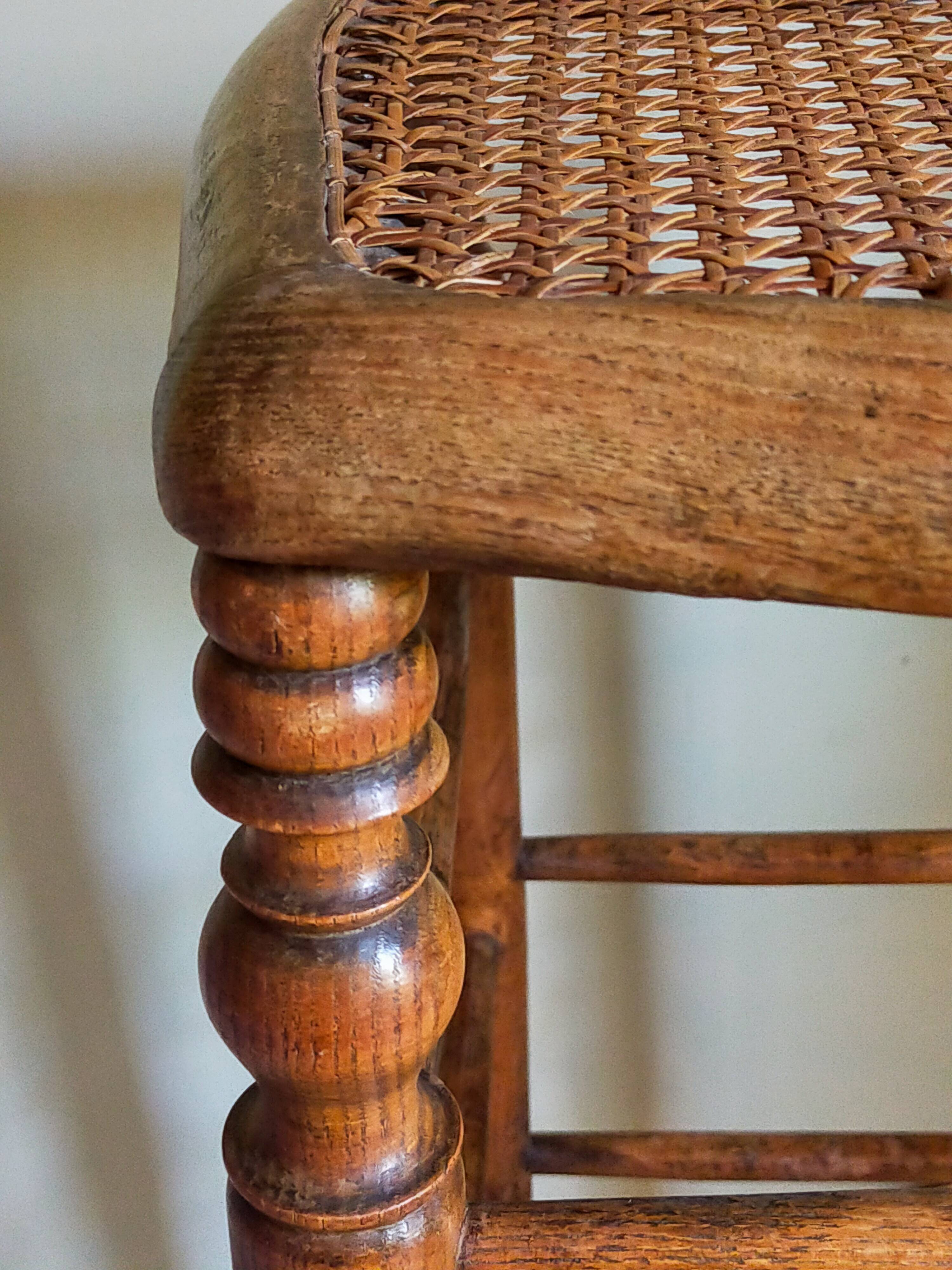 Antique stool with cane and turned wood