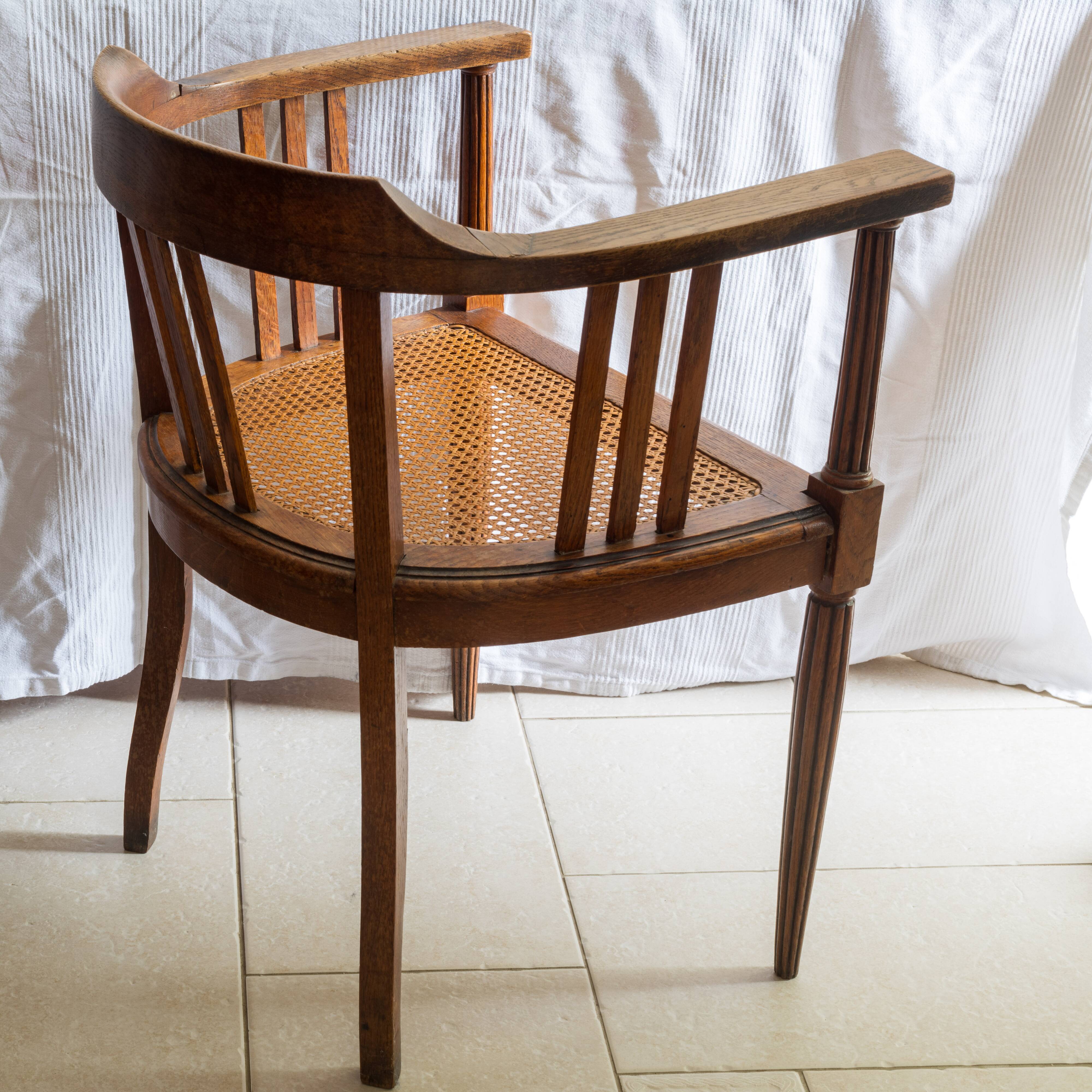 Antique armchair and stool with caned seat and fluted legs