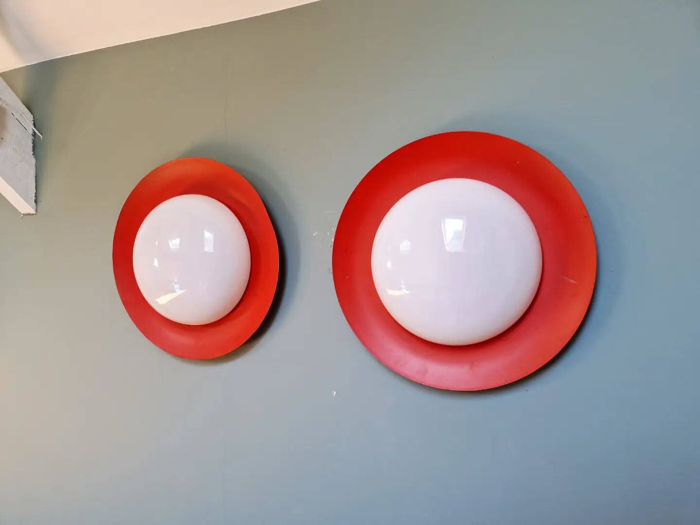 Pair of XXL Space Age wall sconces, orange lacquered metal and opaline, 1960.