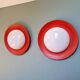 Pair of XXL Space Age wall sconces, orange lacquered metal and opaline, 1960.