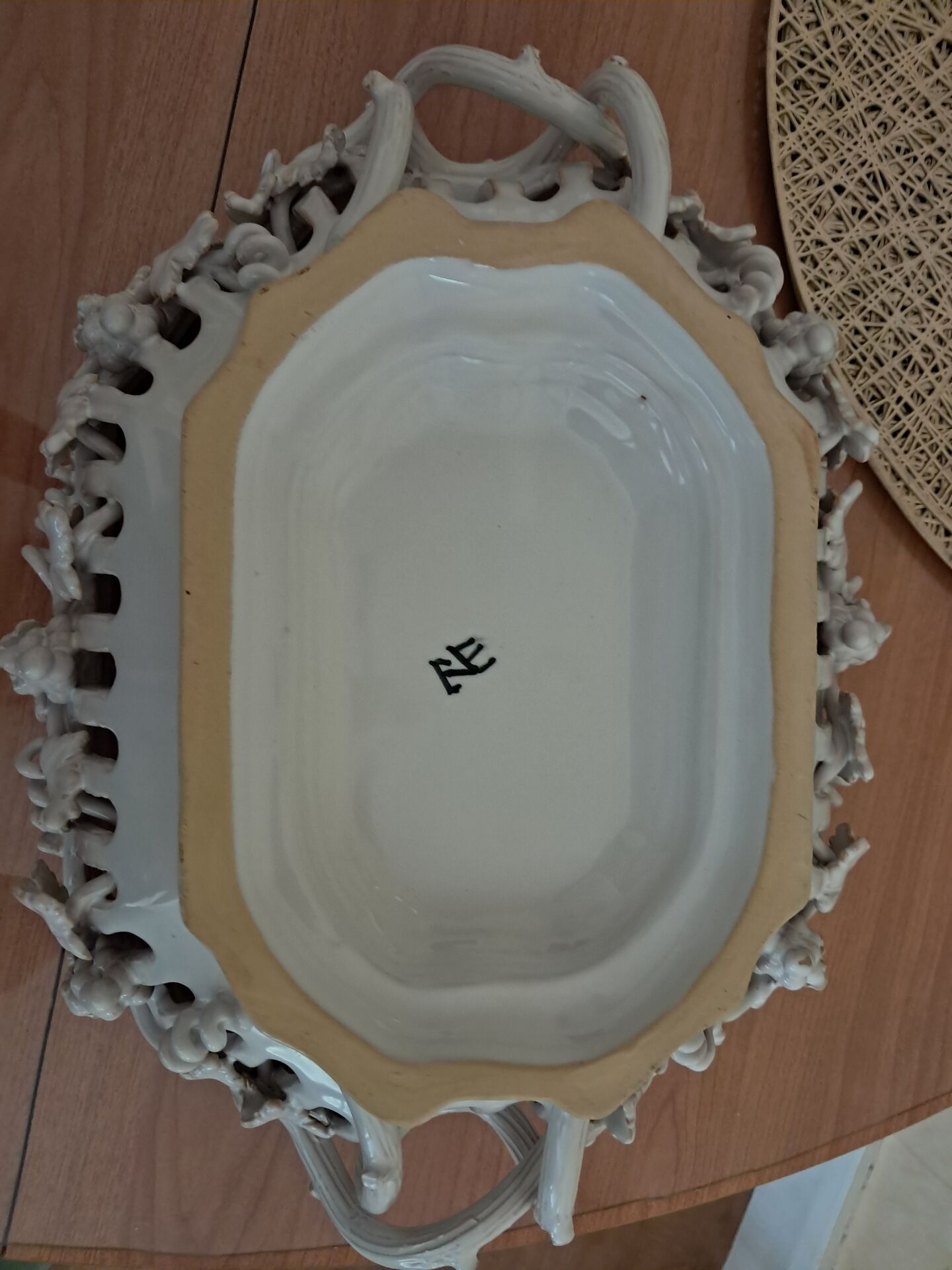 Malicorne fruit bowl in white pierced faience with monogram TE.