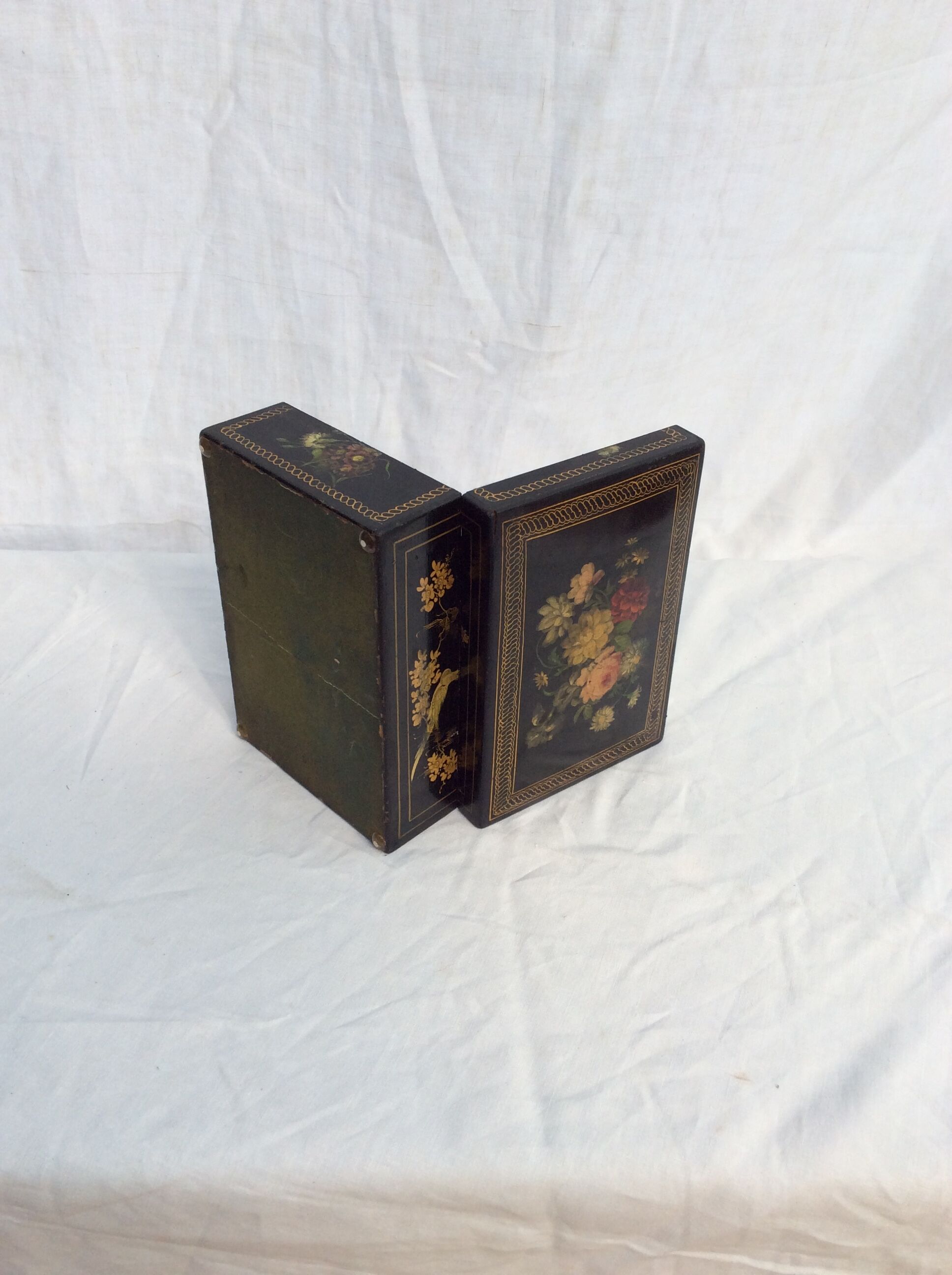Old black wooden box adorned with roses with keys