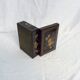 Old black wooden box adorned with roses with keys