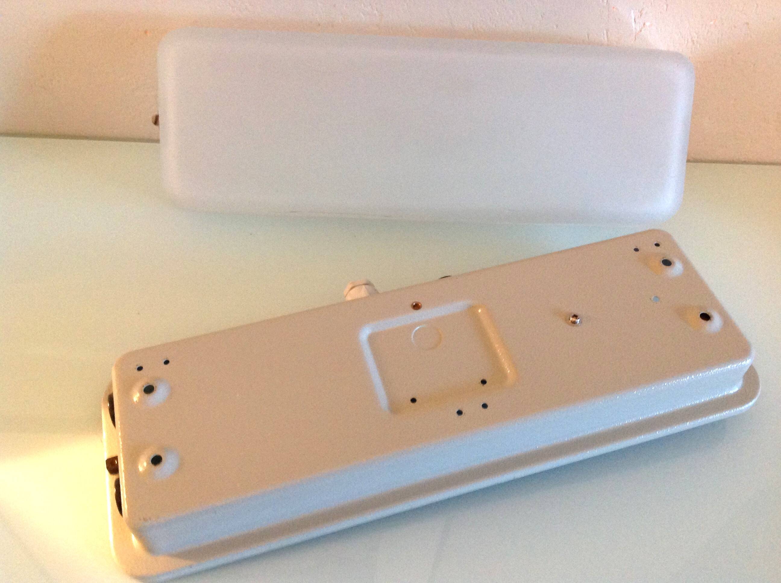 Rectangular porthole wall light in industrial/70s style frosted glass