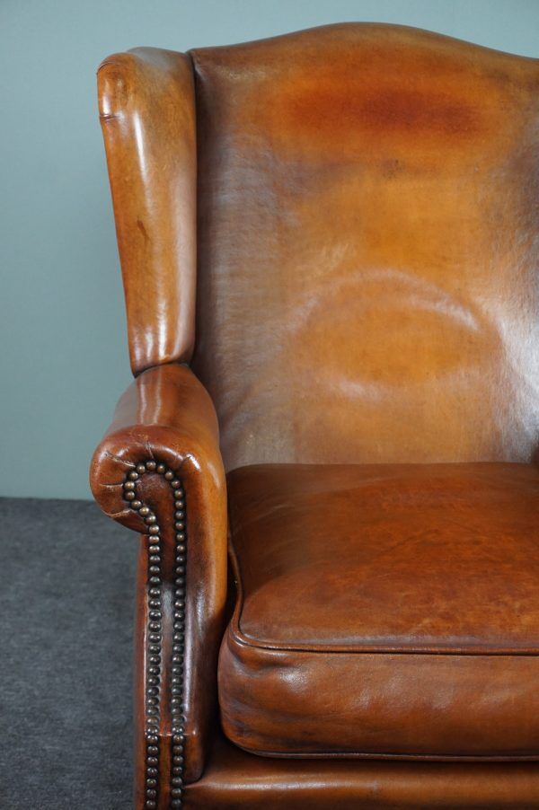 Eared armchair in patinated sheepskin