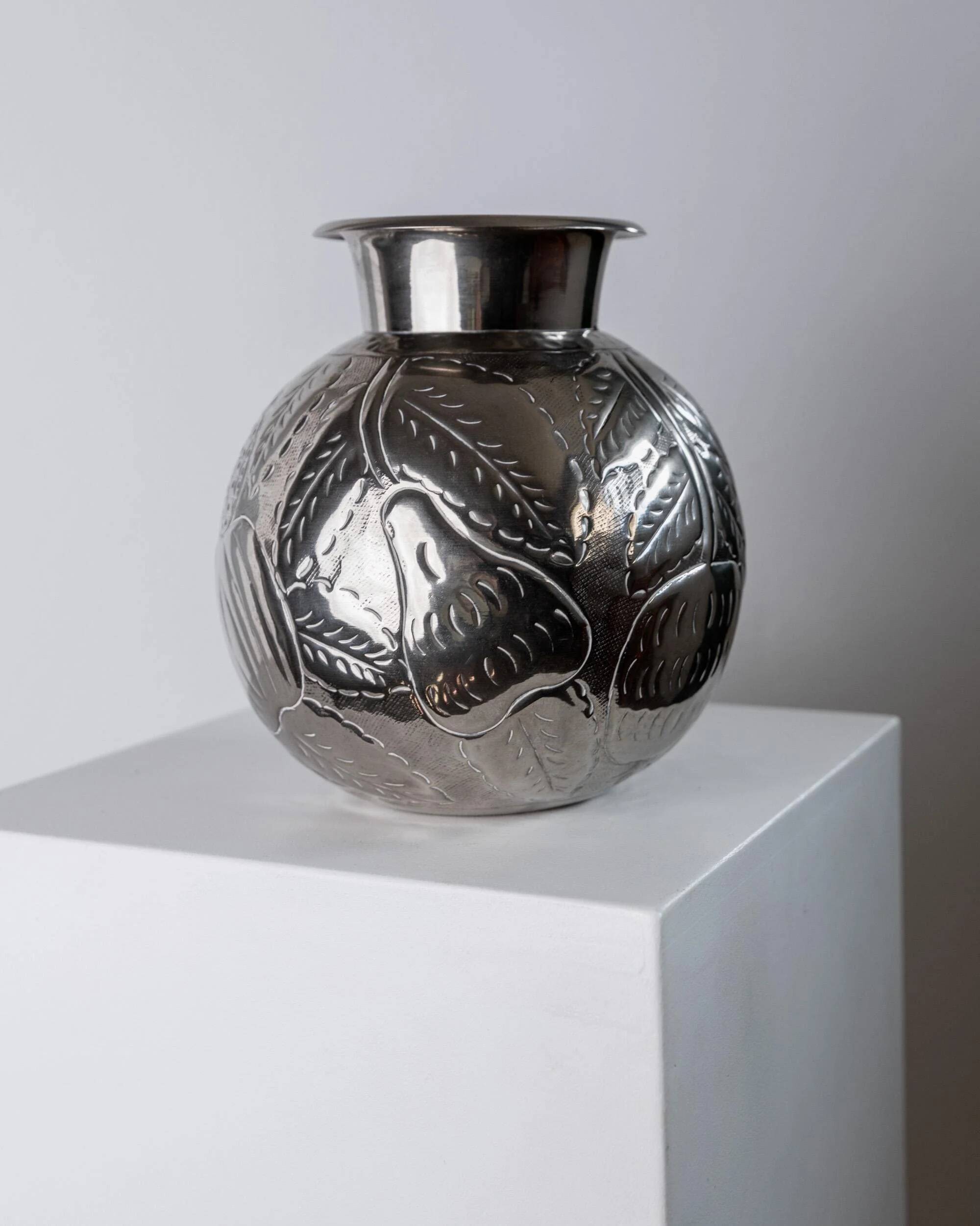 Vintage Italian vase in nickel-plated brass from the 1960s, hand-hammered relief of fruits and leaves.