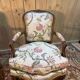 Pair of Louis XV style armchairs with floral fabric.