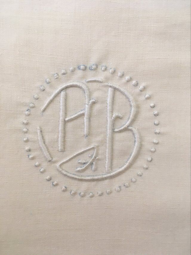 Two matching mixed pillowcases embroidered A B