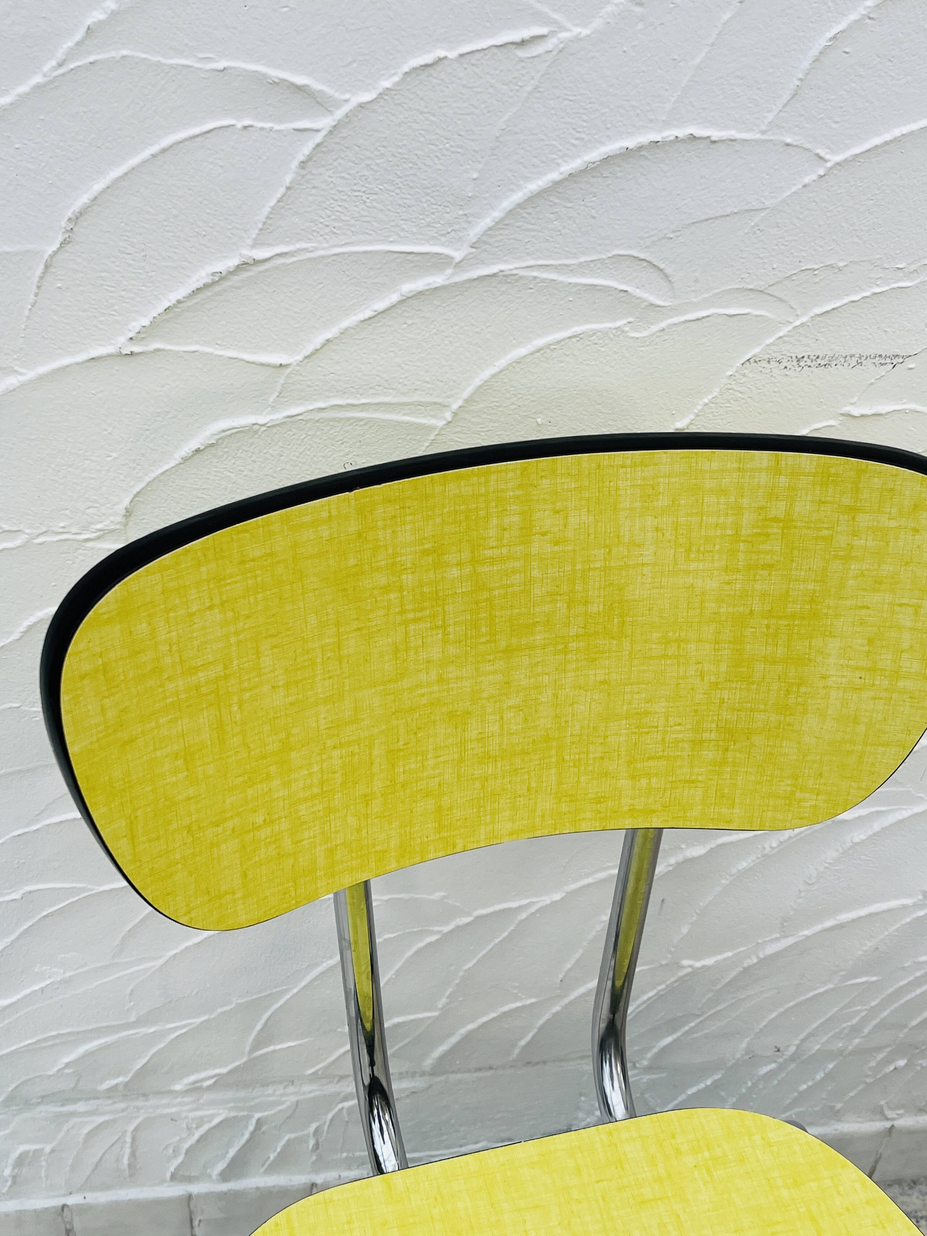 Pair of vintage yellow chrome Formica kitchen chairs.