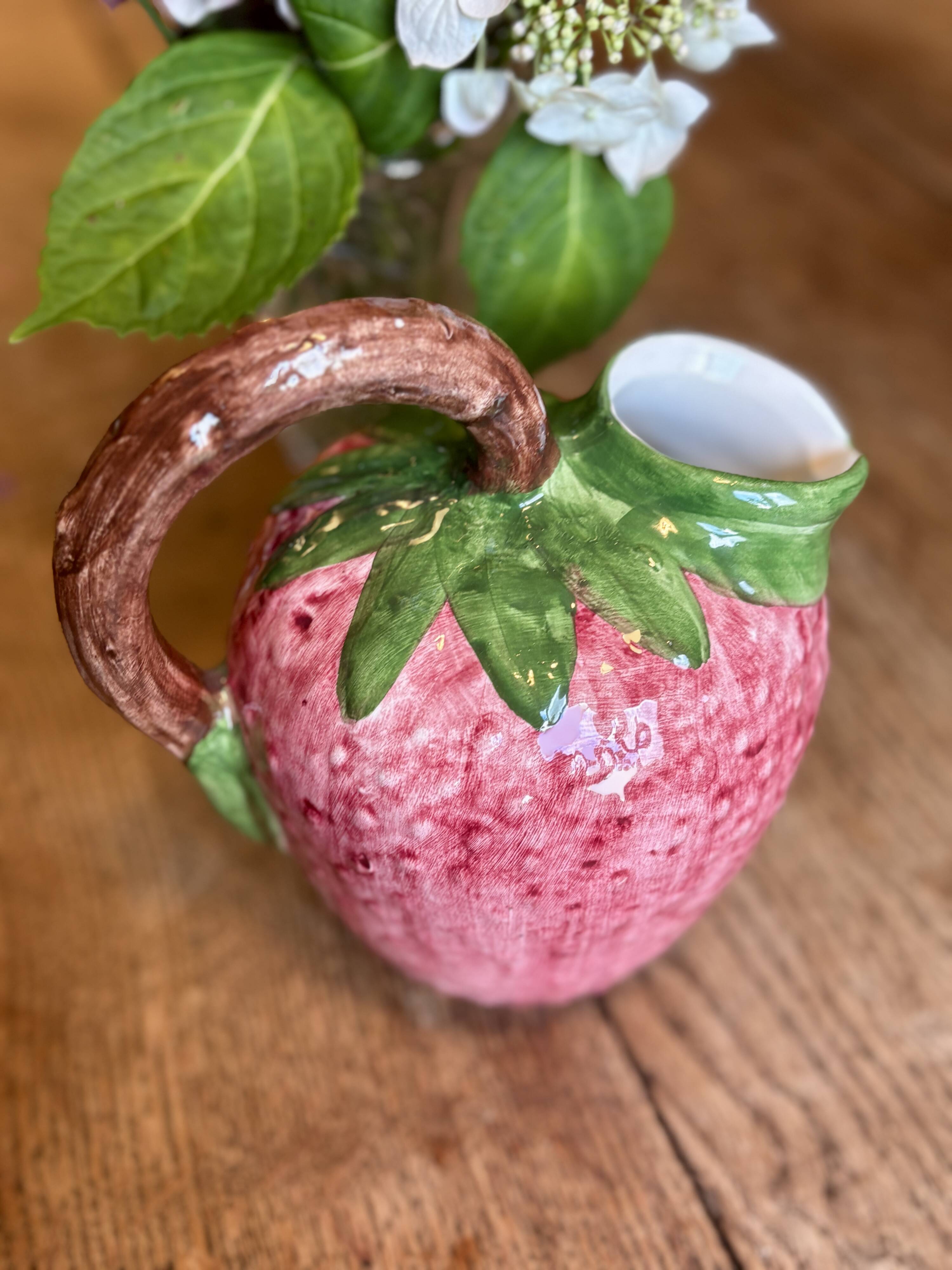 Ceramic jug in the shape of a strawberry.