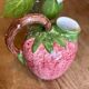 Ceramic jug in the shape of a strawberry.