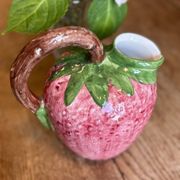 Ceramic jug in the shape of a strawberry.