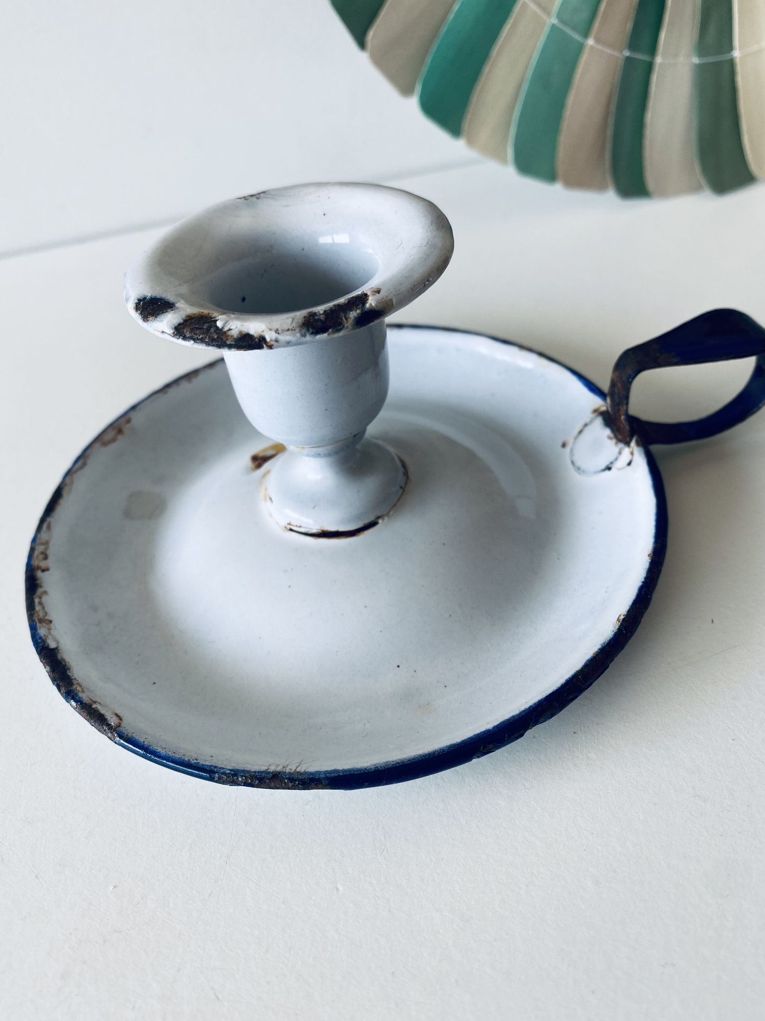 Antique candle holder in white and blue enamelled metal