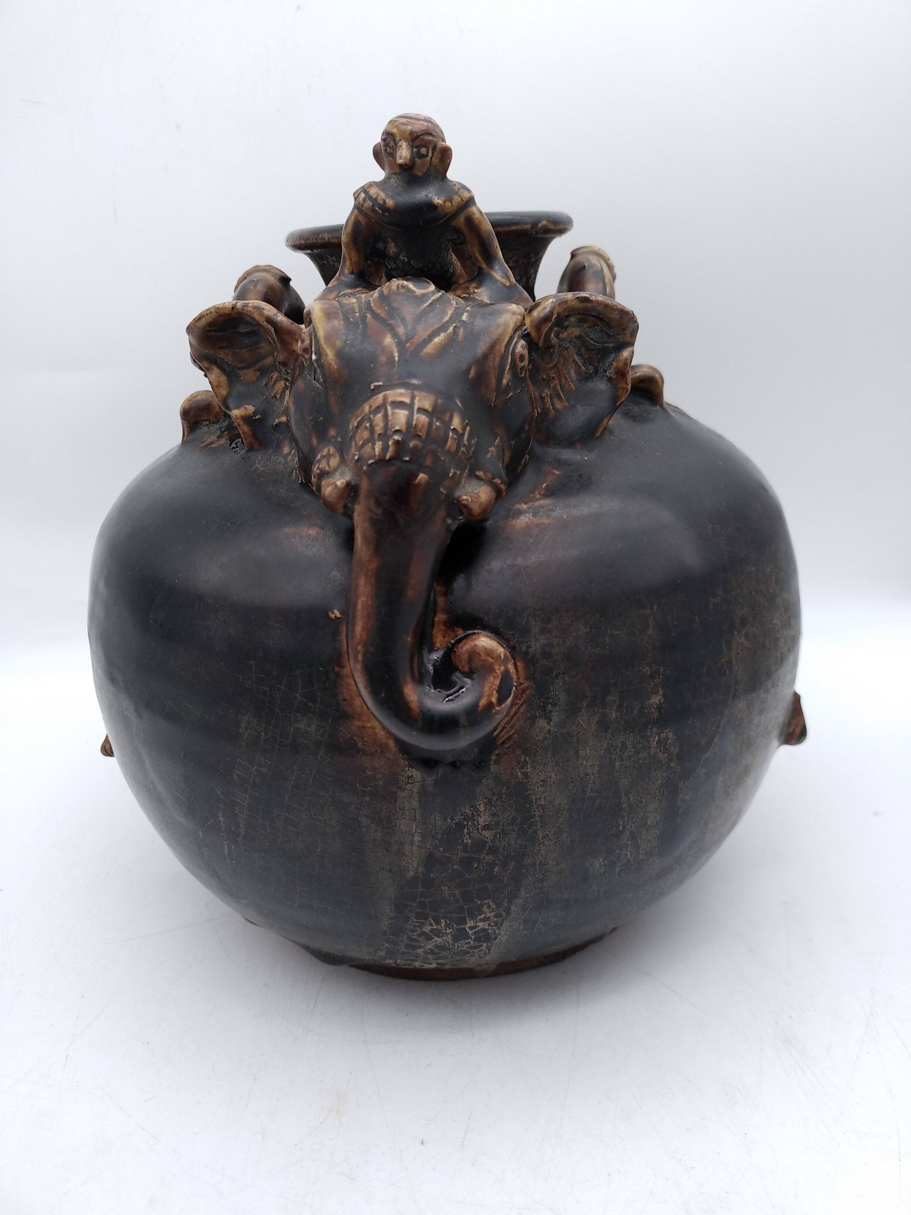 Antique Khmer ceramic vase. With elephant decoration.